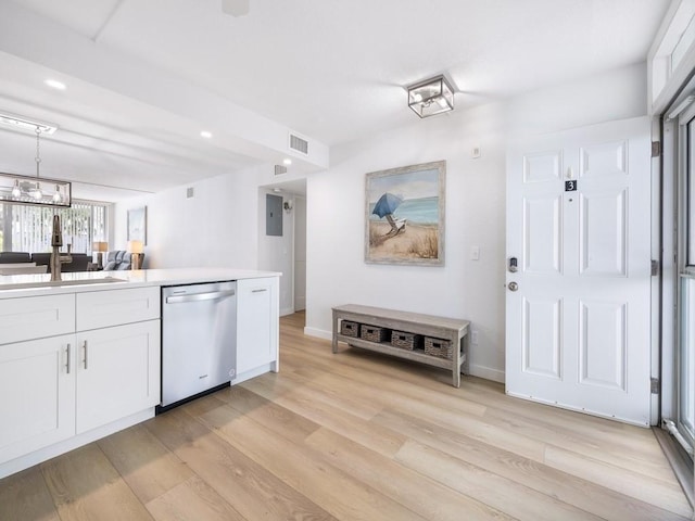 kitchen with stainless steel dishwasher, a sink, light wood-style flooring, and visible vents