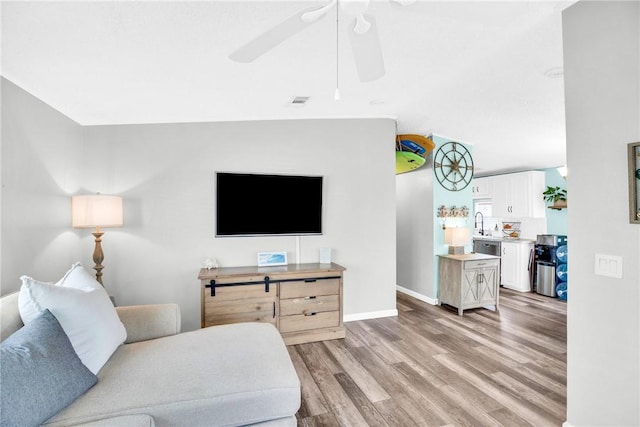 860 Pirates Cove Ln, Fort Pierce, FL 34949 - living area with light wood-style flooring, a ceiling fan, and baseboards
