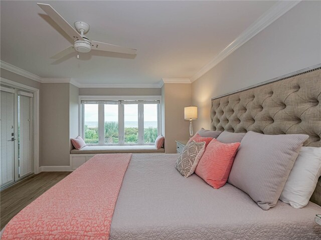 bedroom with hardwood / wood-style floors, ceiling fan, and crown molding