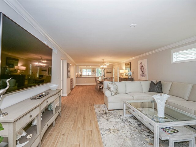 living room with ornamental molding, plenty of natural light, and light hardwood / wood-style floors