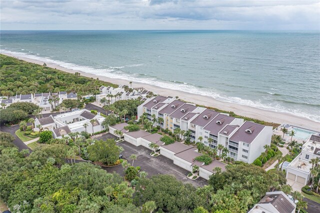 drone / aerial view with a water view and a beach view