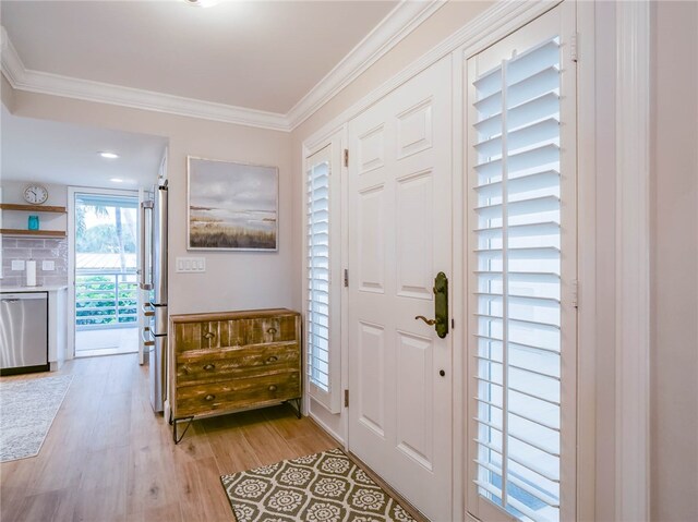 entryway featuring light hardwood / wood-style floors and crown molding