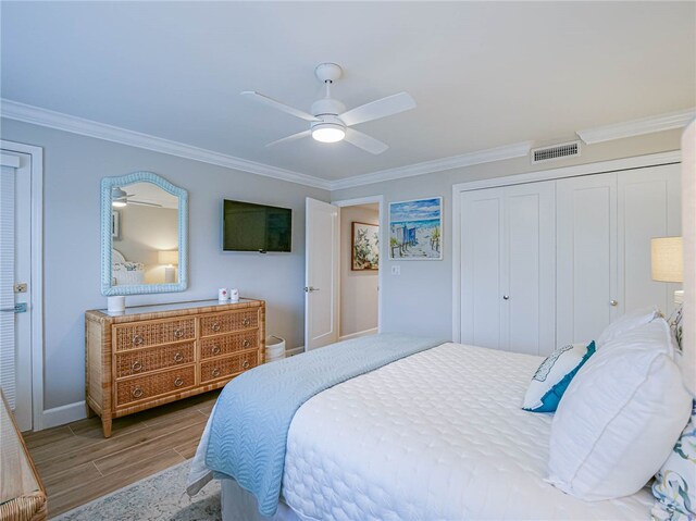 bedroom featuring wood-type flooring, ceiling fan, and crown molding