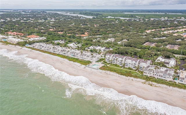 drone / aerial view with a beach view and a water view