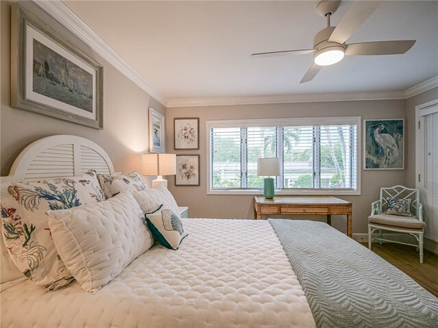 bedroom with hardwood / wood-style floors, ceiling fan, and crown molding