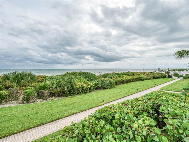 surrounding community featuring a water view and a yard