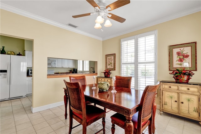 dining room featuring ceiling fan, light tile patterned floors, and ornamental molding