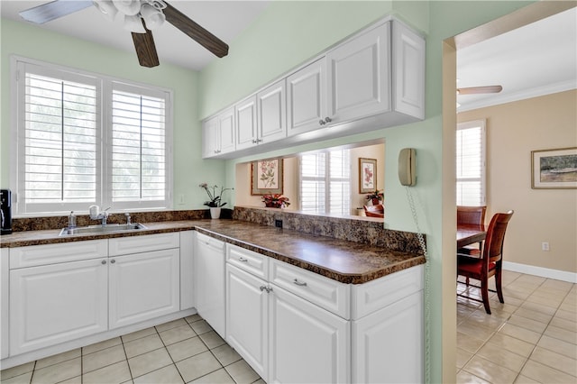 kitchen with white cabinetry, sink, light tile patterned flooring, and plenty of natural light