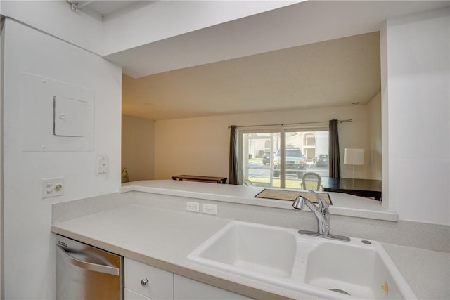 1845 Robalo Dr Unit 101D, Vero Beach, FL 32960 - kitchen featuring stainless steel dishwasher, light countertops, white cabinetry, and a sink