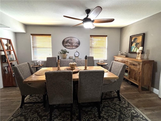 dining area with dark hardwood / wood-style flooring, a textured ceiling, and ceiling fan