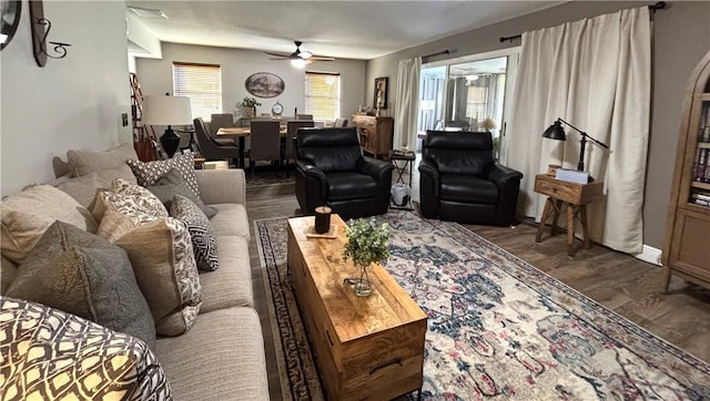 living room featuring dark hardwood / wood-style floors and ceiling fan