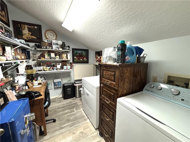 clothes washing area with washer hookup, light hardwood / wood-style floors, and a textured ceiling