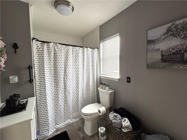 bathroom featuring a shower with curtain, hardwood / wood-style floors, and toilet