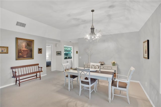 103 W Park Shores Cir Unit 10W, Vero Beach, FL 32963 - dining room featuring light colored carpet, a chandelier, and baseboards