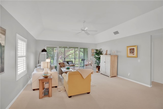 living room with ceiling fan, light carpet, and plenty of natural light