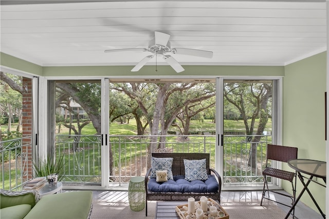 sunroom with a wealth of natural light and ceiling fan