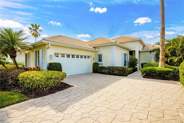 mediterranean / spanish-style home with a garage