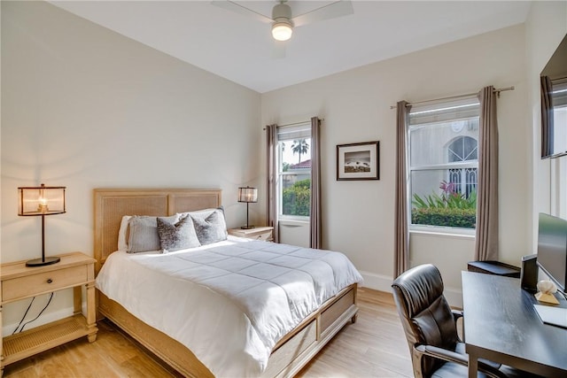 bedroom with light hardwood / wood-style floors and ceiling fan