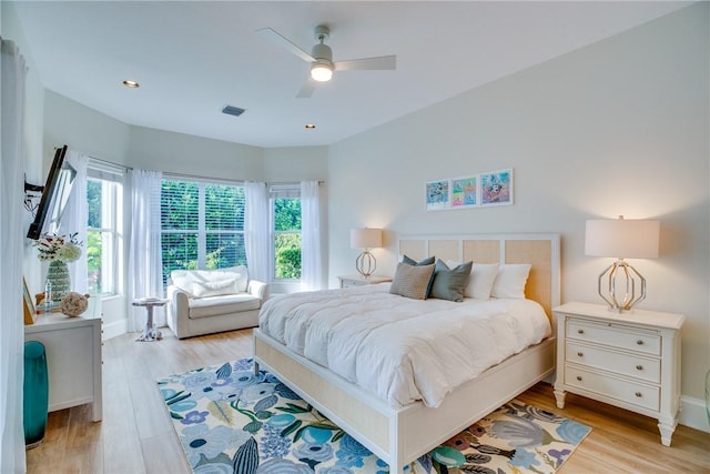 bedroom with ceiling fan and light hardwood / wood-style floors