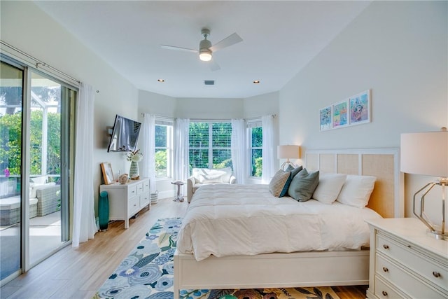 bedroom with access to outside, multiple windows, light hardwood / wood-style floors, and ceiling fan