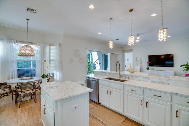 kitchen with stainless steel dishwasher, sink, pendant lighting, white cabinets, and light hardwood / wood-style floors