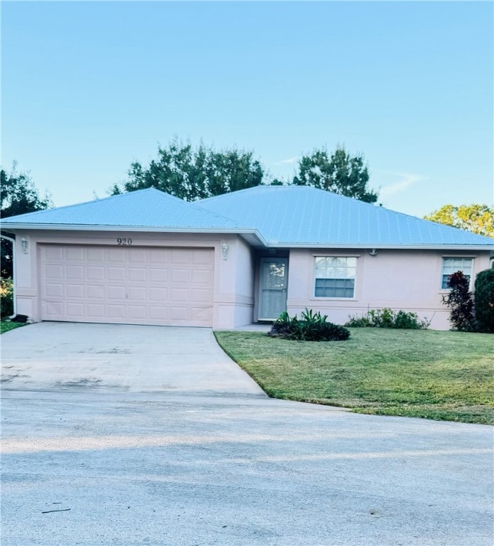 ranch-style home featuring a garage and a front lawn