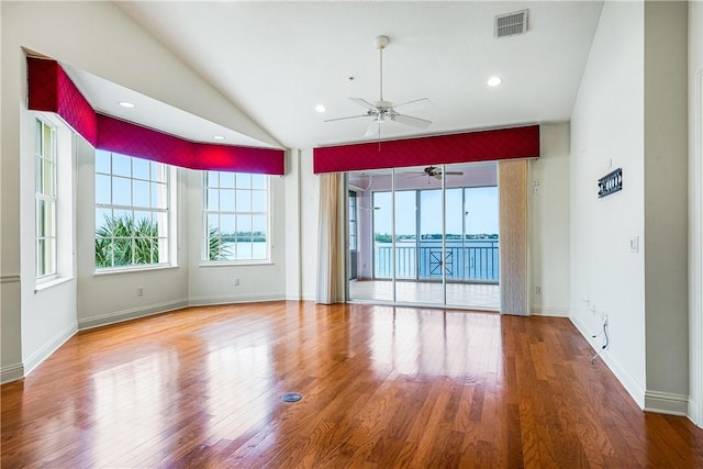 unfurnished room featuring hardwood / wood-style flooring, ceiling fan, and vaulted ceiling