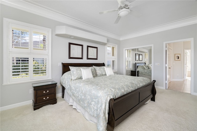 carpeted bedroom featuring crown molding and ceiling fan