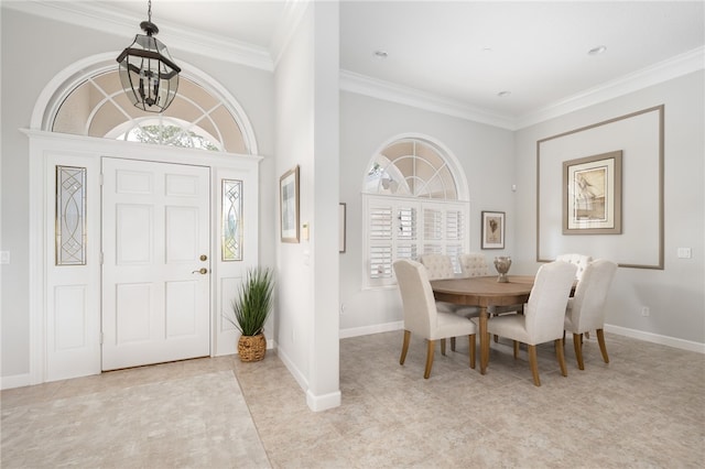 tiled entryway with an inviting chandelier and crown molding