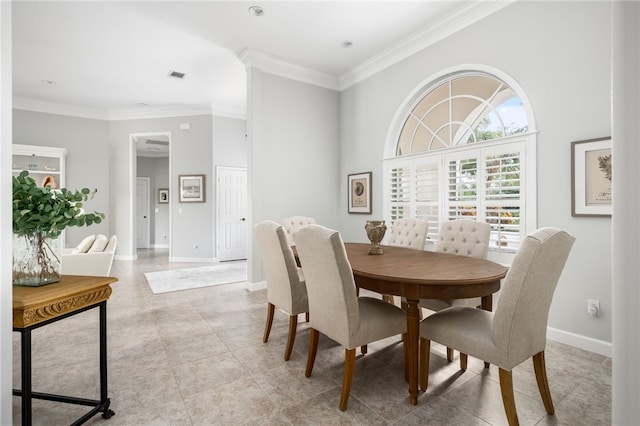 dining area featuring light tile patterned flooring and ornamental molding