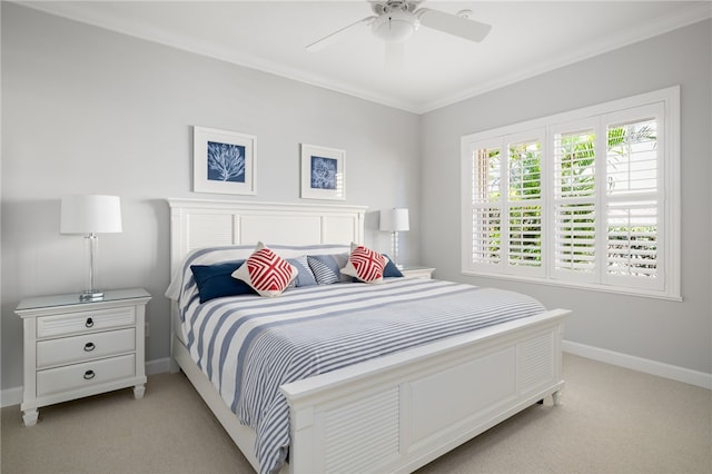 bedroom with ornamental molding, light colored carpet, and ceiling fan