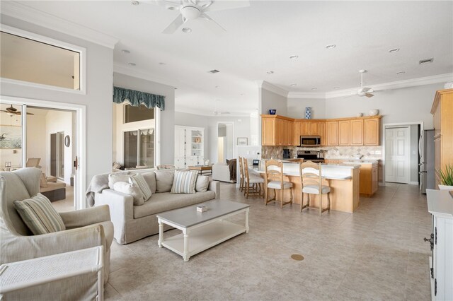 living room featuring crown molding and ceiling fan