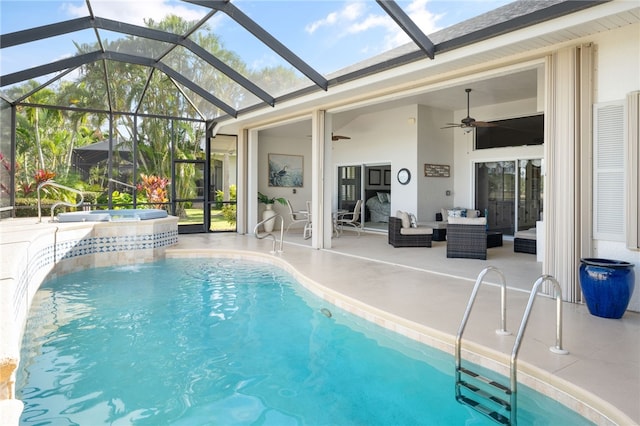 view of pool with a lanai, ceiling fan, outdoor lounge area, a patio, and an in ground hot tub