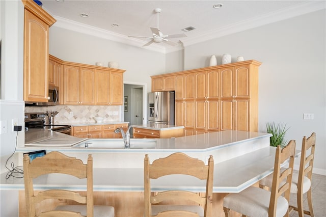 kitchen with stainless steel appliances, tasteful backsplash, ornamental molding, and light brown cabinetry