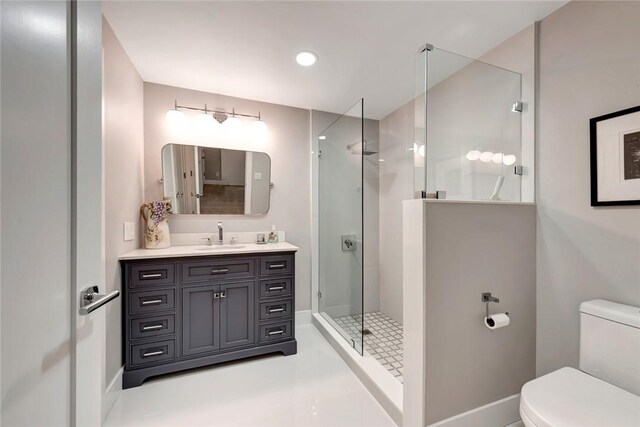 full bathroom with vanity, toilet, and a tile shower