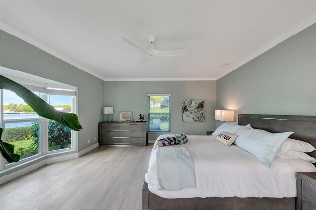 bedroom with ceiling fan, baseboards, light wood-type flooring, and ornamental molding