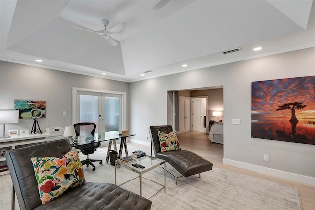 office space featuring recessed lighting, a tray ceiling, visible vents, and light wood-style flooring