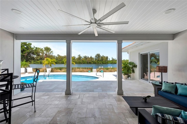 outdoor pool with an outdoor hangout area, a water view, ceiling fan, and a patio area