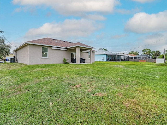 back of property featuring a yard