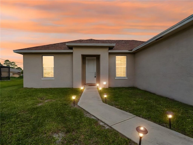 exterior entry at dusk with a yard