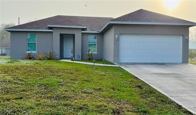 ranch-style house featuring a garage and a yard