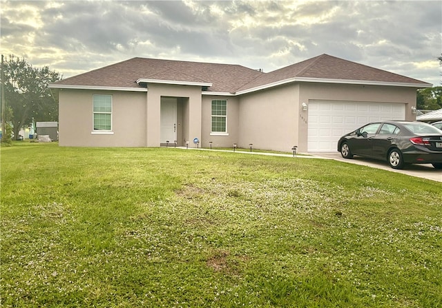 single story home featuring a front lawn and a garage