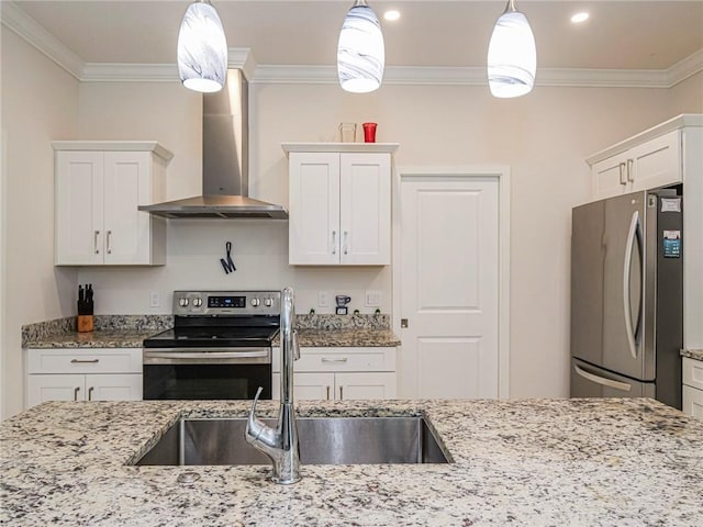 kitchen with stainless steel appliances, white cabinetry, wall chimney exhaust hood, and decorative light fixtures