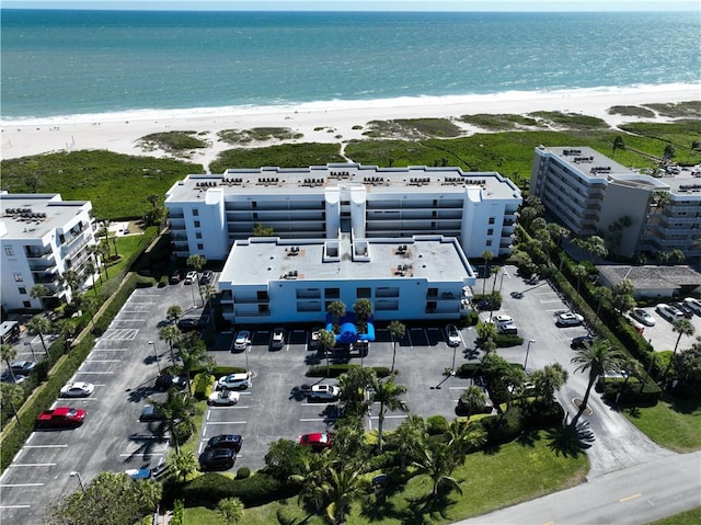 drone / aerial view of expansive coastline and apartment complex / building