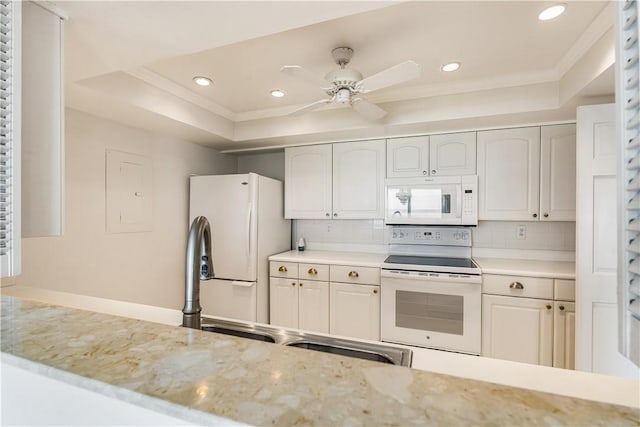 kitchen featuring white appliances, a raised ceiling, ceiling fan, recessed lighting, and decorative backsplash