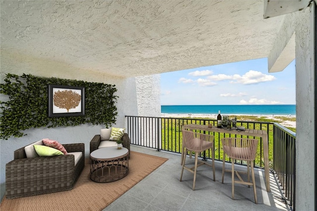 balcony featuring view of water and beach