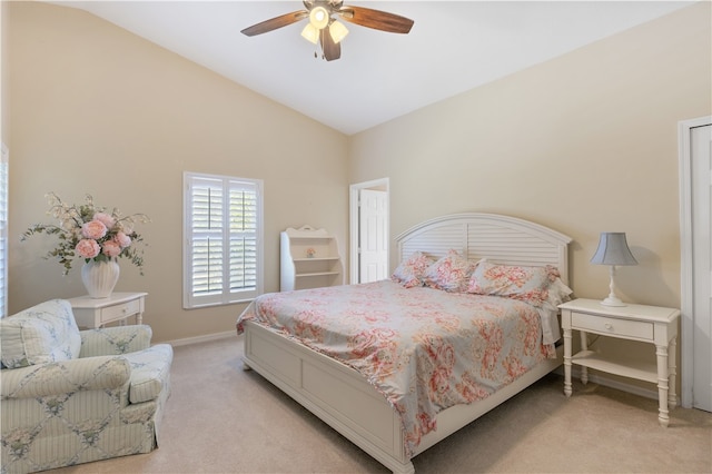 bedroom with ceiling fan, lofted ceiling, and light colored carpet