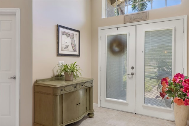 doorway with french doors and light tile patterned floors