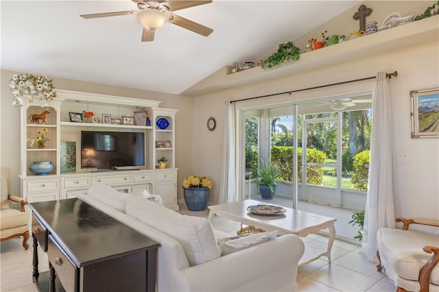 living room featuring lofted ceiling, light tile patterned floors, and ceiling fan