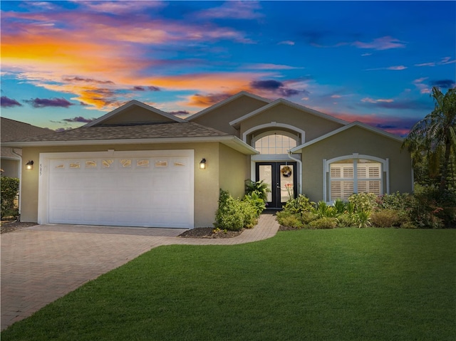 view of front of home featuring a lawn and a garage